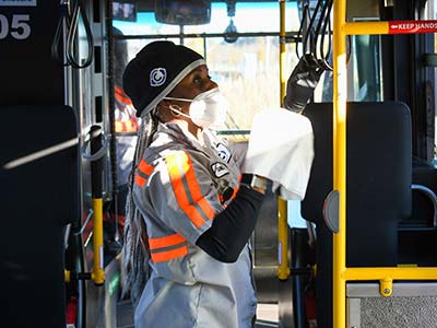C-TRAN employee cleaning inside of bus