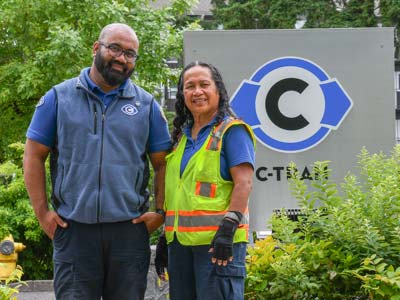 Chris and Perise Tyler stand in front of the sign at the C-TRAN administration building.